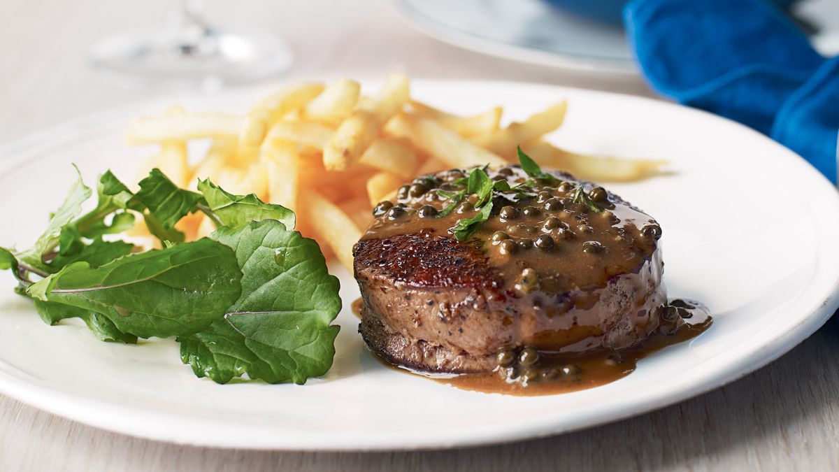 Steak au Poivre with Mushroom, Green Peppercorn, and Dijon Sauce, served alongside Pommes Frites with Garlic Aioli and Fresh Vegetable Relish
