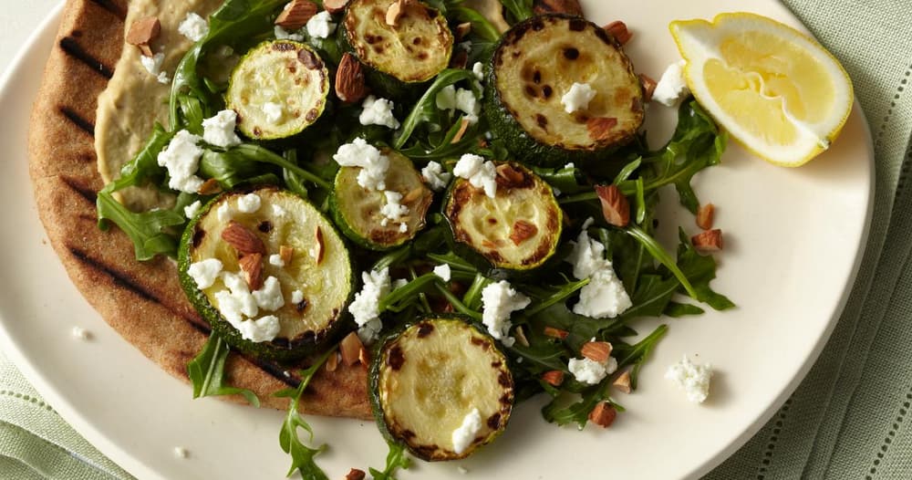 Roasted Zucchini Flatbread with Hummus, Arugula, Goat Cheese, and Almonds Recipe
