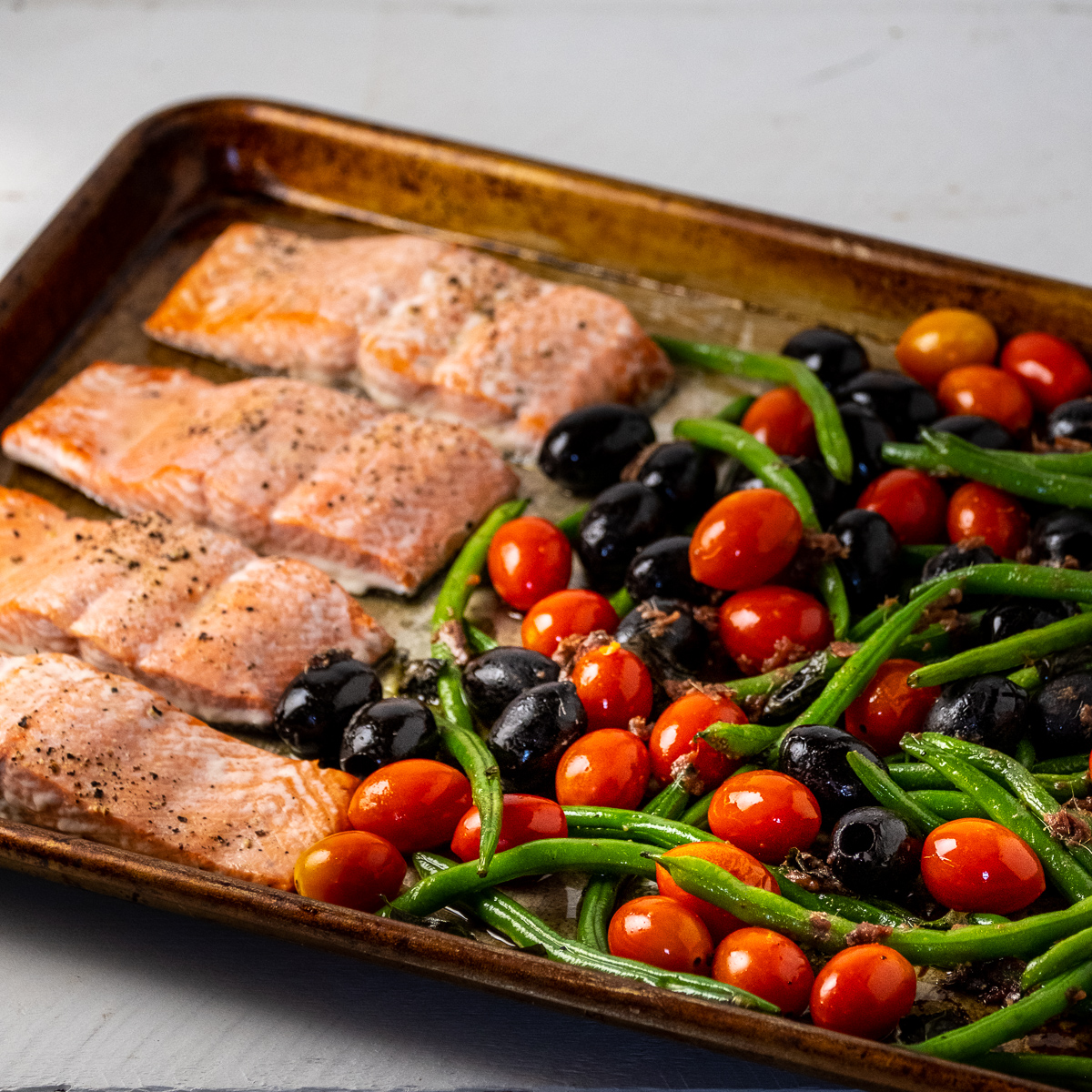 Tray Baked Salmon with Olives, Green Beans, Anchovies and Tomatoes Recipe
